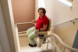 Woman Sitting on Folded Helix Curved Stair Lift
