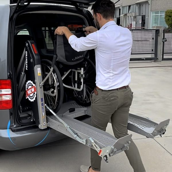 Person Putting Wheelchair Using Double Arm Baby Van Lift Person Putting Wheelchair Using Double Arm Baby Van Lift