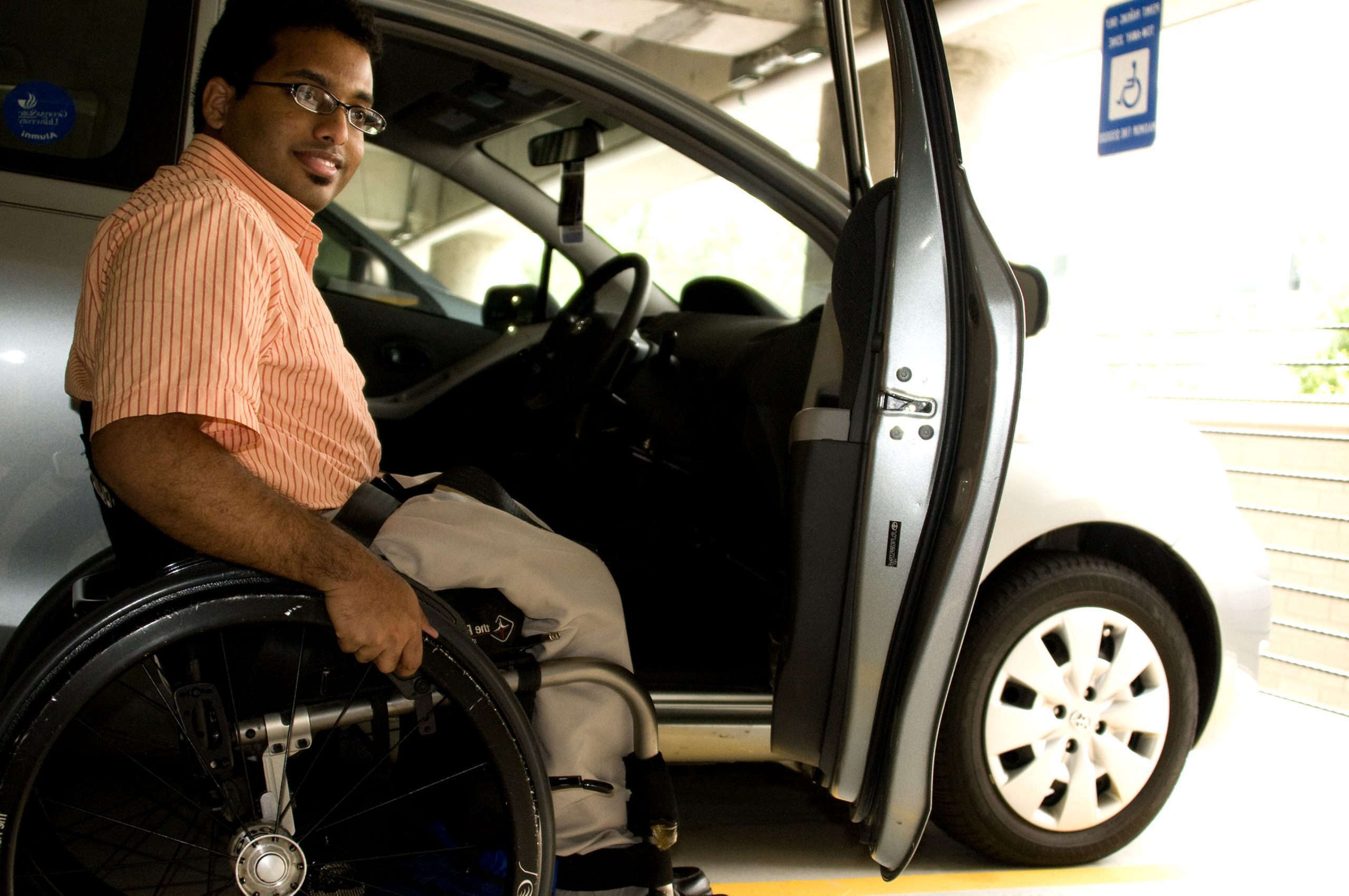 Man in wheelchair next to his car