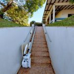 Folded Bespoke Synergy Straight Stairlift Outside Home