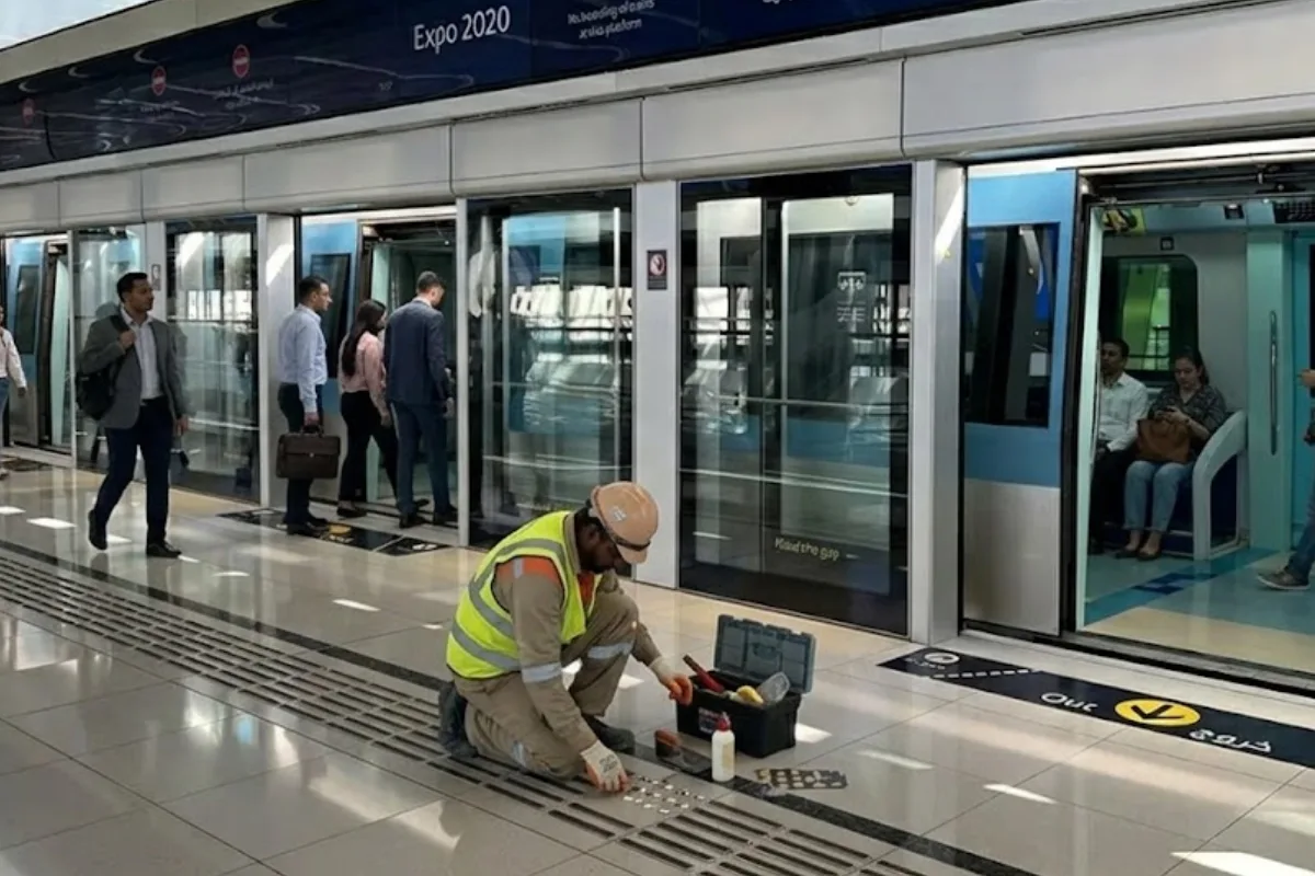 A Person Fixing Tactile Indicators Inside Dubai Metro Station