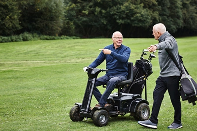 Community Senior Man on Mobility Scooter at Golf Course