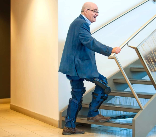 Man with Keeogo Exoskeleton walking up stairs Man with Keeogo Exoskeleton walking up stairs