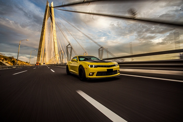 yellow-sport-car-with-black-autotuning-bridge.webp